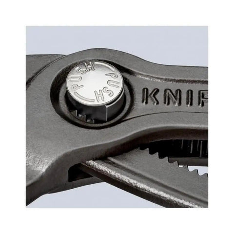Close-up of the push button on Cobra Water Pump Pliers 10 Inch With Self Locking Grip Quick Touch Button Adjustment