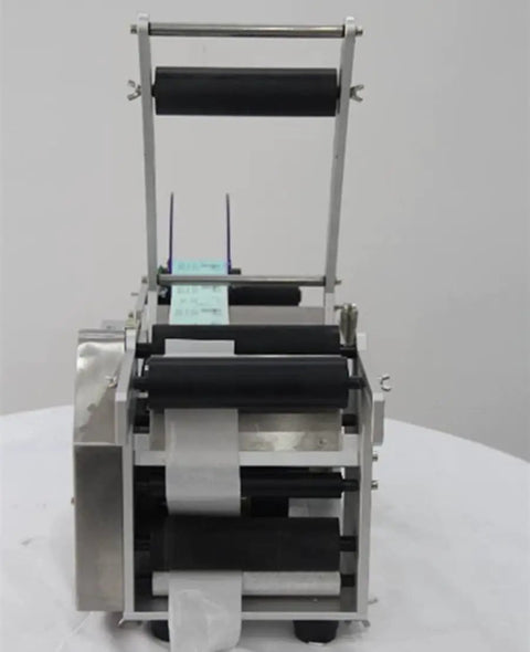 Semi Auto Round Bottle Labeling Machine For 15-30 Pcs Per Minute Speed with aluminum alloy frame and label rolls.