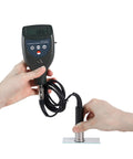 Pro Grade Digital Roughness Tester And Surface Profile Gauge With Separate Cabled Probe For Blast Cleaned Surfaces, 0-800 Micrometers And 0-29.5 Mils Range, Tungsten Carbide Tip Lasts 20k Readings, Rugged On The Go in use with hands holding device and probe.