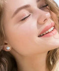 Smiling woman wearing Snag These Fresh Flat Back Earrings Made From Light As Air Titanium Surgical Steel With Diamond Like Cubic Zirconia.