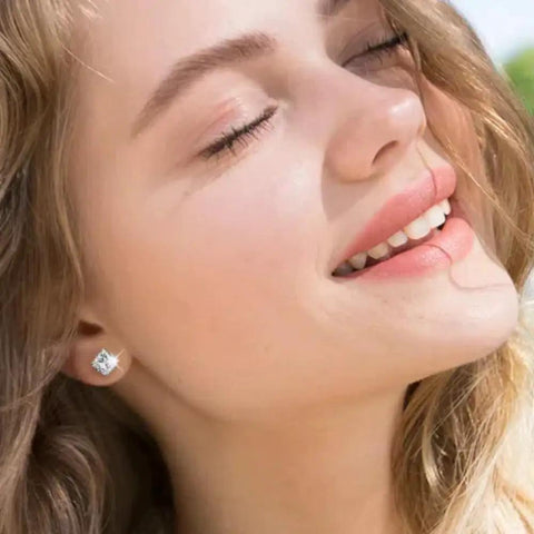 Smiling woman wearing Snag These Fresh Flat Back Earrings Made From Light As Air Titanium Surgical Steel With Diamond Like Cubic Zirconia.