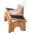 Person using Under Desk Adjustable Foot Rest With Three Level Incline, 7 Inch Wooden Foot Stool For Home And Office, Comfy Ergonomic Support.