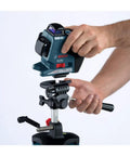 Person adjusting a lightweight heavy duty aluminum elevator tripod with precise centimeter and millimeter and feet and inches graduations