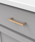 Heritage Designs Contemporary Cabinet Pull 3-3/4 Inch Center to Center Brushed Brass Finish installed on gray cabinet drawer