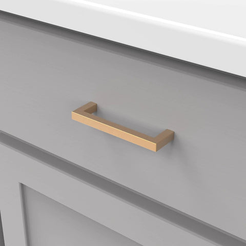 Heritage Designs Contemporary Cabinet Pull 3-3/4 Inch Center to Center Brushed Brass Finish installed on gray cabinet drawer