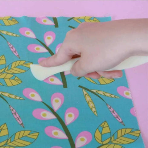 Two Point Turner Sewing Tool With Dual Points And Spatula End For Tight Corners And Seams, White, being used on fabric