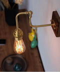Vintage Brass Wall Sconce, Industrial Wood Light Fixture on walnut base with adjustable arm and vintage bulb.
