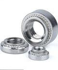 Pro Grade M3 Self Clinching Nuts Feature A Serrated Flange That Locks Into Sheet Metal Smoothly So Your Gear Stays Locked Down On Server Rack Mounts And Tough Shop Builds 200 Pack, three stainless steel nuts showcasing serrated flanges.