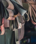 Hanging premium platen grinder sanding belts replacement for Master Tool and Rogers machines at 14 by 103 inches.