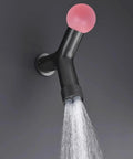 Top Tier Concealed Recessed Shower System Wall Mounted Dual Function Brass Body Matte Black Finish with pink knob and water flow.