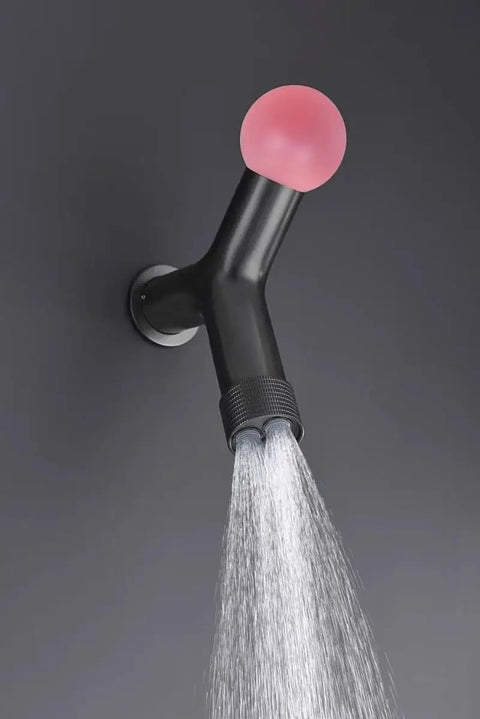 Top Tier Concealed Recessed Shower System Wall Mounted Dual Function Brass Body Matte Black Finish with pink knob and water flow.