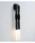 Elegant U Shaped Horsehair Wall Lamp In Sleek Black Delivering Crisp Cool White Glow For Living Rooms And Hallways.