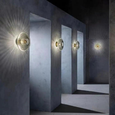 Awsinil Fluted Glass Wall Sconce, Modern Iron Round Decorative Wall Light mounted on grey wall, illuminating textured shadows.