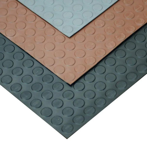 Layers of Coin Pattern Rubber Flooring 3.5mm Thick 36 Inch By 10 Foot Sheet Dark Gray No Slip Surface overlapping in different colors.