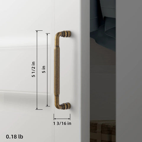 Side view of Antique Brass Cabinet Pull Handles Six Pack 5 Inch Vintage Vertical Grooved Textured Grip installed on a white cabinet.