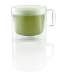 Glass mug with green matcha latte foam, demonstrating Milk Café Frother With Induction Heating Delivers Rich Creamy Foam For Lattes And Cappuccinos.