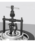Shop Pro Built Tough 5 To 10 Ton Hydraulic Three Jaw Bearing Puller Kit close-up of tool in use for hub extraction.
