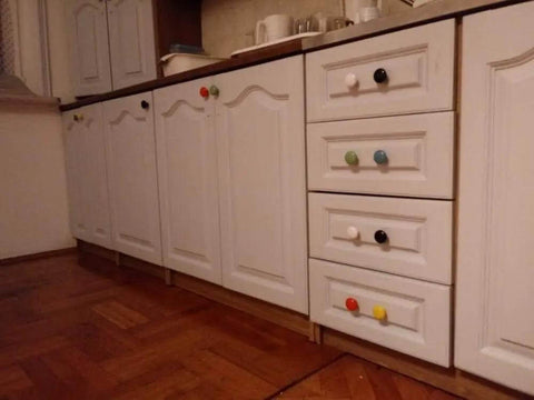 Total Room Glow Up With Durable Yellow Ceramic Round Cabinet Knobs And Easy Grip Handles Perfect For Dressers Kitchens Closets And Cupboards, showing colorful ceramic knobs on white cabinetry.