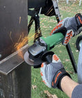 Person using Powerful 4-1/2 Inch Angle Grinder With 12 Amp AC Brushless Motor, Variable Speed on metal beam outdoors.