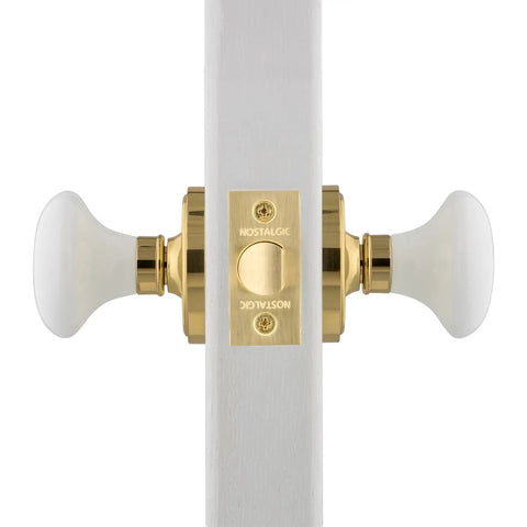 Porcelain Door Knob Set With Classic Rosette For Hallways And Closets White Ceramic Knobs Polished Brass Finish Old School Retro Passage Hardware Two And Three Quarters Inch Backset Complete For One Door Easy Install Great For Restoration Projects, side view