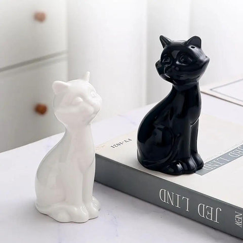 Chill Out Your Bathroom Look With This Ridiculously Cool Set Of Two Ceramic Cat Toilet Bolt Caps That Hides Exposed Bolts Hassle Free And Brings Serious Vibe In Matte Black, featuring matte black and white ceramic cats.
