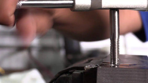 Using the Top Tier High Speed Steel Hand Tap Set Covers 8 Through 36 Fractional Sizes for re-threading a bolt.