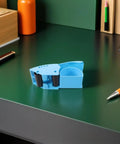 Blue Ergonomic Packing Tape Dispenser And Cutter For Quick Box Sealing With Smooth Glide And Broad Tape Compatibility on desk