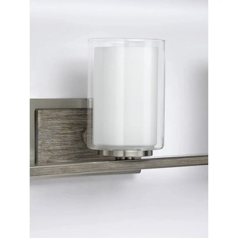 Detail of the Four Light Linear Chandelier with brushed nickel finish, faux wood back plate, and glass shades for spa vibe bath lighting.