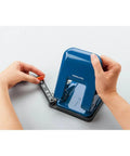 Person adjusting paper guides on Heavy-Duty 2-Hole Punch With Smooth Action, Handles Up To 37 Sheets, blue ergonomic design, top view