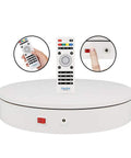 ComXim Motorized Turntable Remote Control Rotating Display Stand 360 Degree Platform with remote, power switch and disk surface.