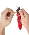 Fastback Press And Flip Utility Knife With Belt Clip And Onboard Wire Stripping Red Set Of 4 in use wire stripping