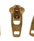 Zipper Repair Kit With Brass Size Four Point Five Pants Sliders Three Sliders Per Pack For Jeans And Other Pants Easy To Install Replacements For Broken Zippers Works On Denim Chinos Jackets Includes Top And Bottom Stops Made In USA, showing three brass zipper sliders in a row.