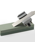 6 Inch Green Silicon Oxide Sharpening Stone 2 Sided Coarse And Fine Grit For Sharpening Knives Tools And Chisels Bench Stone For Oil Or Water Lubrication 6 X 2 X 1 Inches with knife being sharpened