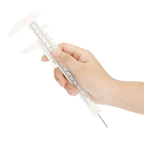Hand holding waterproof plastic caliper eyebrow lip tattoo ruler for permanent makeup accurate measuring tool