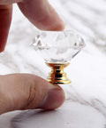 Hand holding 8 Pack Crystal Glass Cabinet Knobs with Gold Base, diamond style, for kitchen cabinets or dressers, 1.2 inch diameter.
