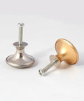 Two cabinet door handles in stainless steel and brass color with screws