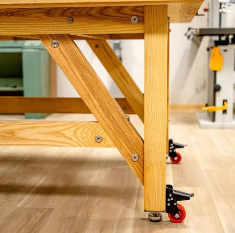 Heavy Duty Steel Caster Set For Router Tables, Workbenches, Cabinets And Tool Stands With 800 LB Capacity installed on workbench leg.