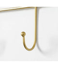 Close-up of gold hook from Heavy Duty Wall Mounted Coat Rack With Sturdy Hooks For Draping Jackets Hats And Outerwear In The Entryway Hallway Bedroom A Simple Setup That Keeps Your Daily Gear Straight Up Tidy.