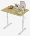 Smooth Operator Manual Standing Desk 48 By 24 Inches with wood top, hand crank mechanism, and workspace accessories.