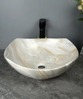 Bathroom Sink Bathroom Sink Marble Ceramic Sink Hotel Bathroom Washbasin Washstand Balcony Vessel Vanity Sink Bathroom Sink Vessel in white with gold veining on a countertop.