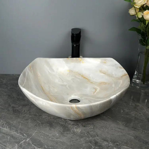 Bathroom Sink Bathroom Sink Marble Ceramic Sink Hotel Bathroom Washbasin Washstand Balcony Vessel Vanity Sink Bathroom Sink Vessel in white with gold veining on a countertop.