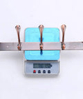 Heavy Duty Stainless Steel Wall Coat Rack With Five Sturdy Hooks For Coats Hats Robes And Towels showing weight on scale.