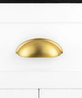 Brushed Gold Cup Drawer Pulls 3 Inch 76mm Set of 10 Durable Metal Cabinet Handles mounted on white drawer front.