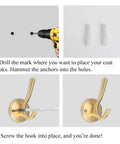 Installation of Heavy Duty Gold Wall Mounted Coat Hooks Set Of 8 With Brass Brushed Finish Robe Hangers using drill and screws.