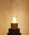 G9 Halogen Bulb 120V 25W T4 Type 2 Pin Base, Dimmable Warm White 2700K, glowing in socket, close-up view