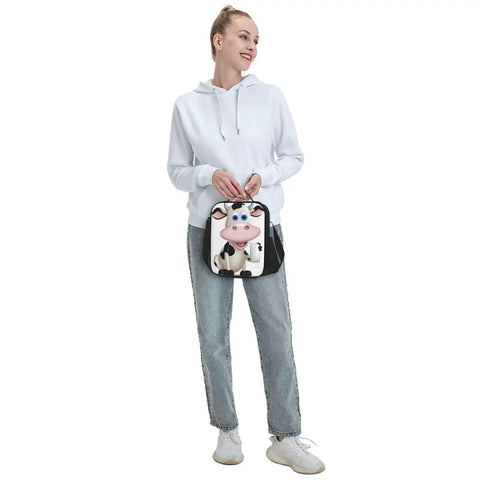 Woman in a white hoodie holding the Ultimate Kickass Insulated Lunch Bag For Guys And Gals Featuring Hella Tough Leak Proof Peva Lining.