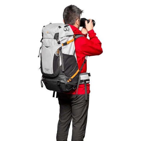 PhotoSport Pro 55L Camera Backpack With Front And Rear Access For DSLR And Mirrorless, worn by photographer in red jacket