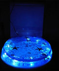 Extended Comfort Resin Toilet Seat With Slow Close Hinge And Heavy Duty Stainless Steel Hardware Designed For No Sweat Cleanup And Top Tier Comfort During Routine Bathroom Visits, lit with blue lights.