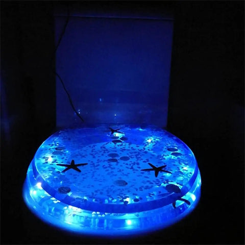 Extended Comfort Resin Toilet Seat With Slow Close Hinge And Heavy Duty Stainless Steel Hardware Designed For No Sweat Cleanup And Top Tier Comfort During Routine Bathroom Visits, lit with blue lights.