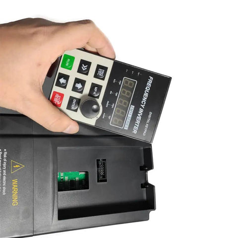 Hand holding control panel of 2HP 110V Input VFD to 220V Output Motor Drive for single phase to three phase motors, variable frequency controller